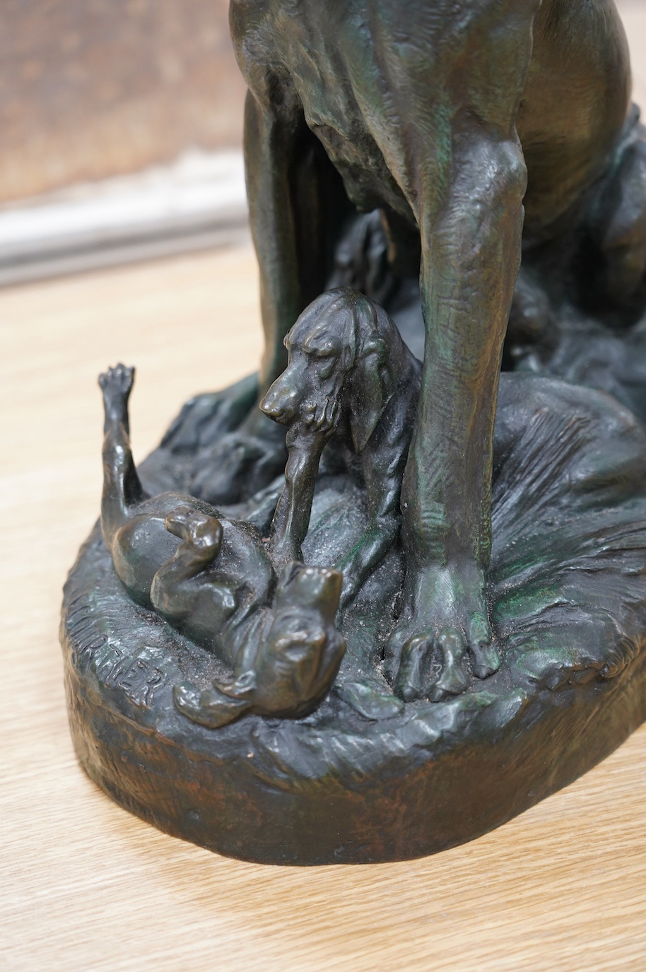 After Prosper Lecourtier (1855-1924), bronze model of a seated bloodhound and puppies, signed, 40cm tall. Condition - fair to good